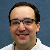 man in glasses smiling